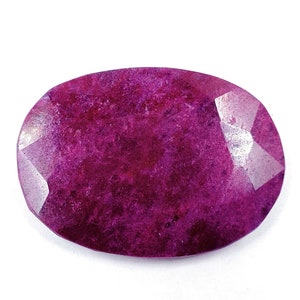 May include: A deep purple oval-shaped gemstone with a faceted cut.