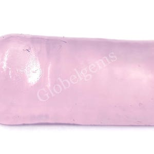May include: A pale pink, smooth, oval-shaped gemstone. The gemstone is translucent and has a slight sheen. The text "Globelgems" is visible in the image.