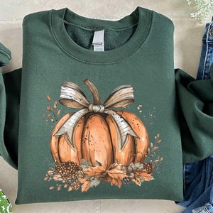 a green shirt with a pumpkin on it