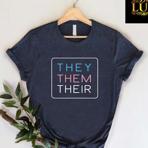 May include: A white ceramic mug with a colorful floral design. The mug features a handle and a glossy finish. The flowers are in shades of pink, purple, and yellow, with green leaves. The mug is likely for beverages.