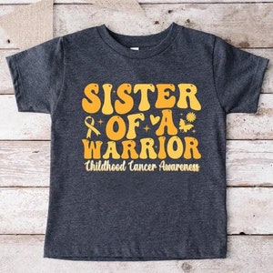 Sister Of a Warrior Childhood Cancer Awareness Shirt,Childhood Cancer Family Shirt,Pediatric Cancer Warrior Gift,Gold Ribbon Kids Cancer Tee