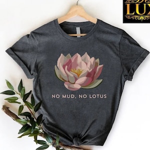 a black t - shirt with a pink flower on it