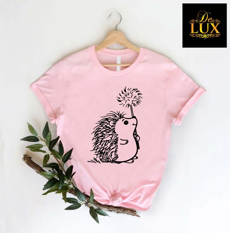 a pink shirt with a hedge on it