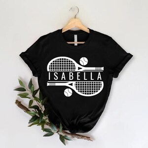 a t - shirt with a tennis racket and ball on it