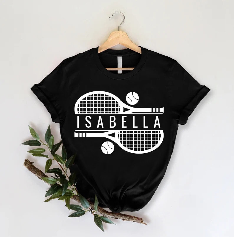 a t - shirt with a tennis racket and ball on it