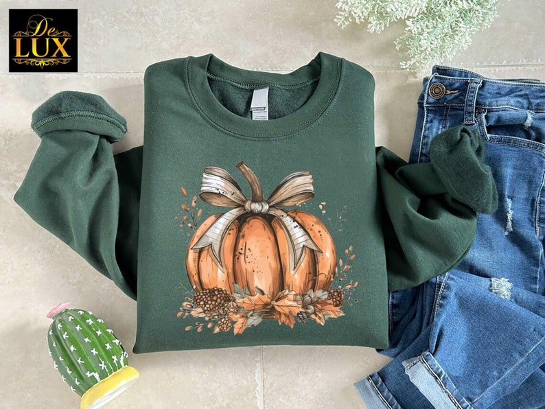 a green shirt with a pumpkin on it