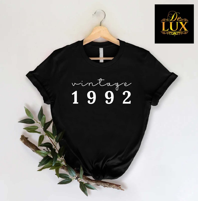 a black t - shirt with the words vintage 1932 printed on it