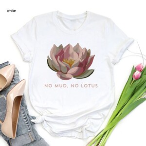 a white shirt with a pink flower on it