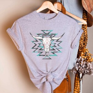 a gray shirt with a cow skull on it
