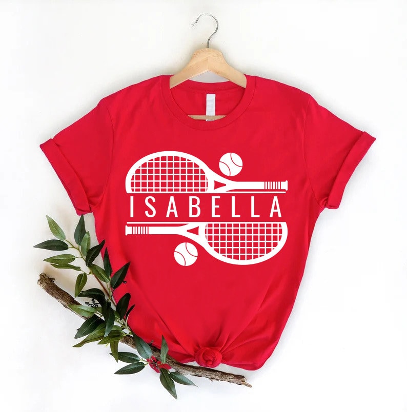 a t - shirt with a tennis racket and ball on it