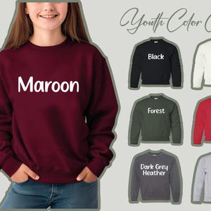 a woman wearing a maroon sweatshirt with the word maroon on it