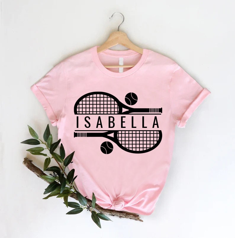 a pink shirt with a tennis racket on it