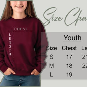 a girl wearing a sweatshirt with a cross on it