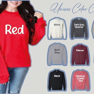 a woman wearing a red sweatshirt and jeans