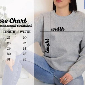 May include: A gray unisex crewneck sweatshirt with a size chart. The chart displays measurements for length and width in inches for sizes S through XXL. The sweatshirt is shown on a person wearing blue jeans.