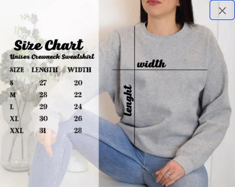 May include: A gray unisex crewneck sweatshirt with a size chart. The chart displays measurements for length and width in inches for sizes S through XXL. The sweatshirt is shown on a person wearing blue jeans.