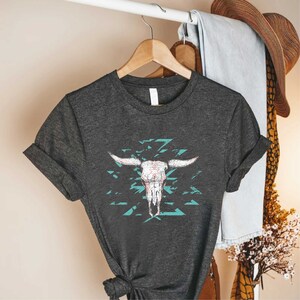 a t - shirt that has a cow skull on it