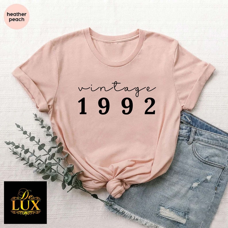 a pink shirt with the words vintage 1932 printed on it