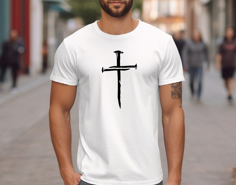 a man wearing a t - shirt with a cross on it