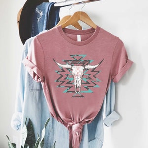 a pink shirt with a cow skull on it