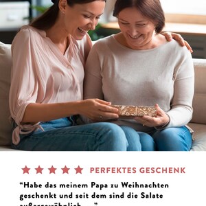 May include: Two people are smiling while looking at a gift box. The text on the image reads "PERFEKTES GESCHENK" and "Habe das meinem Papa zu Weihnachten geschenkt und seit dem sind die Salate au&szlig;ergew&ouml;hnlich..."  Amazon Kunde - 05. Februar 2022