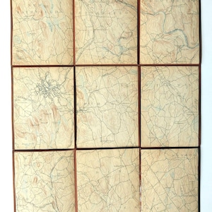 May include: A grid of nine vintage topographical map panels featuring tan paper with black ink lines, contour markings, and blue water features. The maps display geographic regions including New Fairfield, Brookfield, Danbury, Bethel, and Newtown.