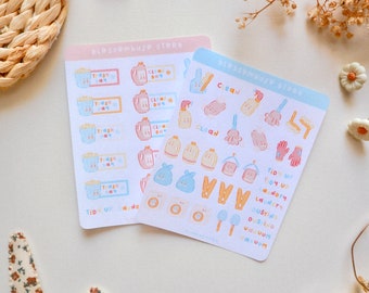 May include: Two sheets of stickers with a light blue and pink background. The stickers feature illustrations of cleaning supplies, laundry, and trash cans. The text on the stickers includes "Clean Day", "Trash Day", "Tidy Up Laundry", "Dusting", and "Vacuum".