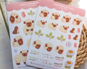 May include: Two sticker sheets featuring cute cartoon sheep with different expressions and poses. The sheets are pink with white borders and include the text "Shelly Flower Field" and "mixed sheet" or "icons sheet".