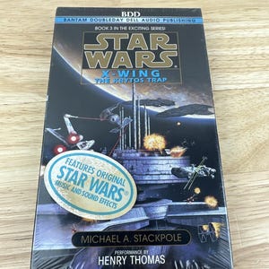 May include: A sealed Star Wars audio book, "X-Wing: The Krytos Trap." The cover features a space battle scene with X-wing fighters and other spacecraft. The book includes original Star Wars music and sound effects. Author Michael A. Stackpole, performed by Henry Thomas.
