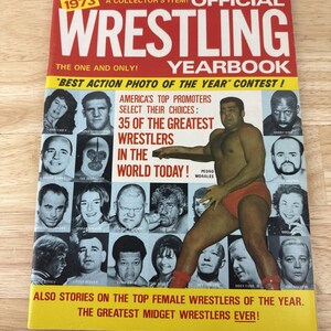 May include: A vintage 1973 Official Wrestling Yearbook magazine. The cover features a wrestler in red trunks and a collage of wrestler portraits. Text includes "35 of the Greatest Wrestlers" and "Best Action Photo of the Year".