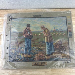 May include: A needlepoint kit featuring a depiction of Jean-François Millet's painting "The Angelus." The kit includes a canvas with a printed design, yarn, and instructions. The kit is packaged in a clear plastic bag with the title "Angelus" and the artist's name "J.F. Millet" printed on the front.