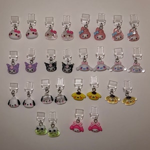 May include: A collection of 20 colourful character charms, featuring popular cartoon characters like Hello Kitty, My Melody, and Kuromi. The charms are attached to clear plastic clips, making them perfect for adding a touch of whimsy to bags, backpacks, or keychains.