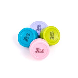 May include: Four colorful, round containers in shades of blue, pink, green, and purple. Each container has the text "Blazy Susan" printed on it in a cursive font. The containers are arranged in a circular pattern against a white background.