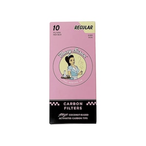 May include: A pink box of Blazy Susan 10 pack of 9mm regular size carbon filters. The box features a cartoon illustration of a woman in a diner uniform. The text on the box reads "Blazy Susan", "EST. DENVER, CO", "CARBON FILTERS", "RIDE COCONUT-BASED", and "ACTIVATED CARBON TIPS".