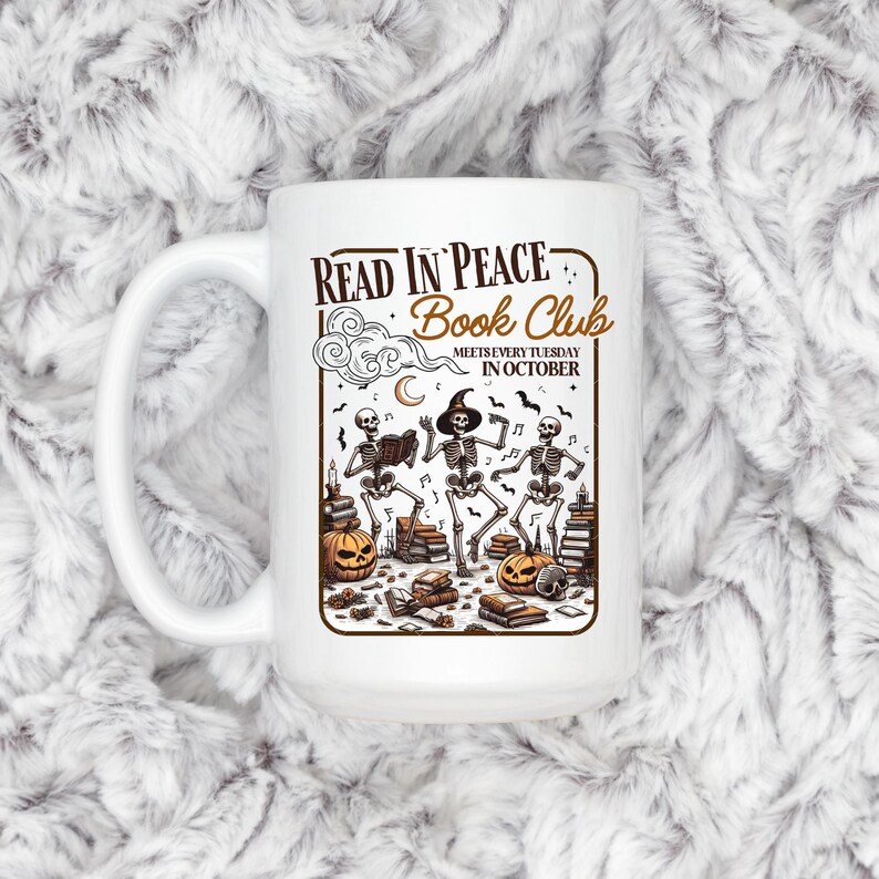 May include: White ceramic mug with a Halloween-themed design. The mug features the text "READ IN PEACE Book Club" and an illustration of skeletons, pumpkins, books, and musical notes. The text "MEETS EVERY TUESDAY IN OCTOBER" is also included.