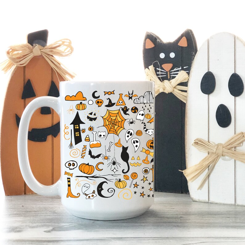May include: White ceramic coffee mug with a black and orange Halloween themed design. The design features a variety of Halloween icons, including pumpkins, bats, ghosts, spiders, and candy corn.