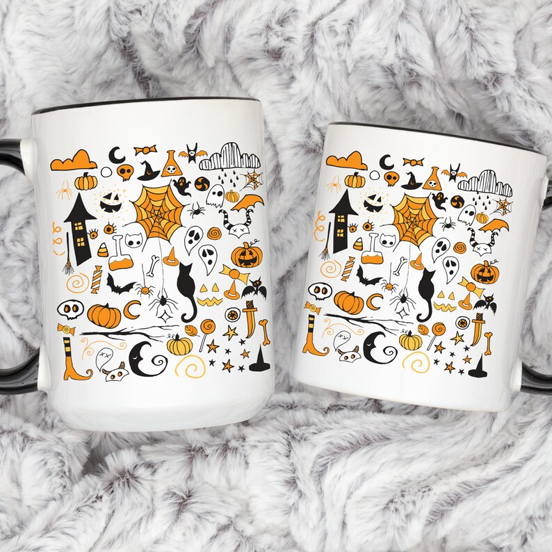 May include: Two white ceramic mugs with black rims, featuring a Halloween-themed design. The mugs are filled with a variety of orange, black, and white illustrations, including pumpkins, ghosts, bats, cats, and candy corn.
