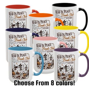 May include: White ceramic mugs with different coloured interiors and handles. Each mug has the text "READ IN PEACE Book Club" and a Halloween illustration. The phrase "Choose From 8 colours!" is at the bottom.