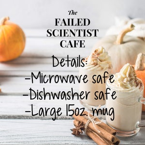 May include: A white ceramic mug with a brown liquid and whipped cream on top. The mug is labeled "The Failed Scientist Cafe" and has the details: "Microwave safe", "Dishwasher safe", and "Large 15oz mug". The mug is sitting on a white wooden surface with cinnamon sticks and a star anise.