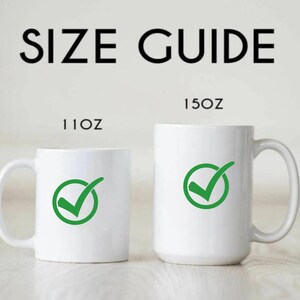 May include: A size guide graphic with the text "SIZE GUIDE" in black. Two white mugs are shown, one labeled "11OZ" and the other "15OZ". Each mug has a green checkmark symbol inside a circle.