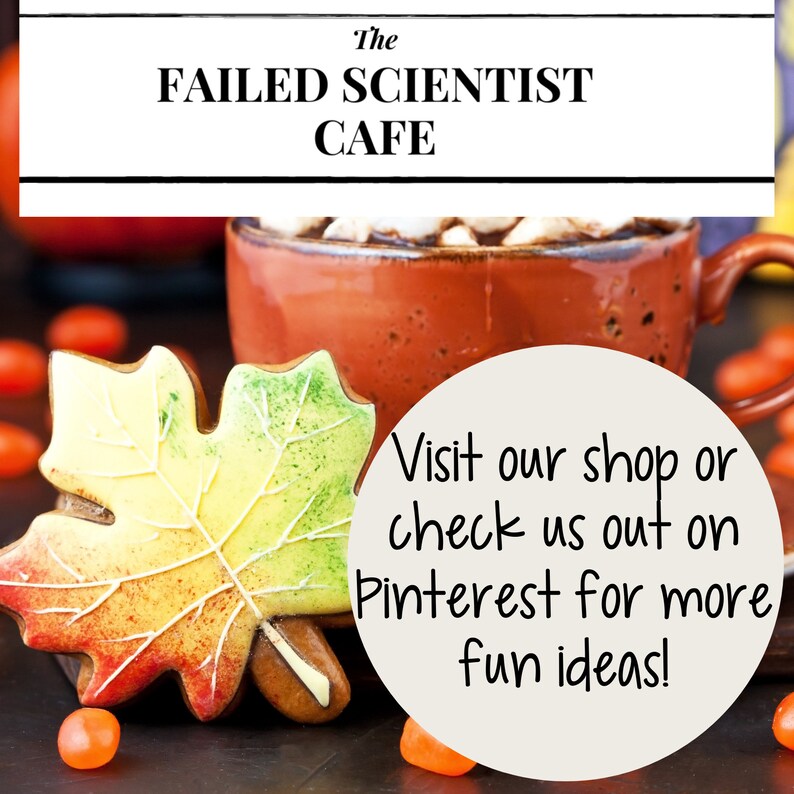 May include: A decorated gingerbread cookie shaped like a maple leaf with red, yellow, and green icing. The cookie is next to a mug of hot chocolate with marshmallows and a white circle with the text "Visit our shop or check us out on Pinterest for more fun ideas!"