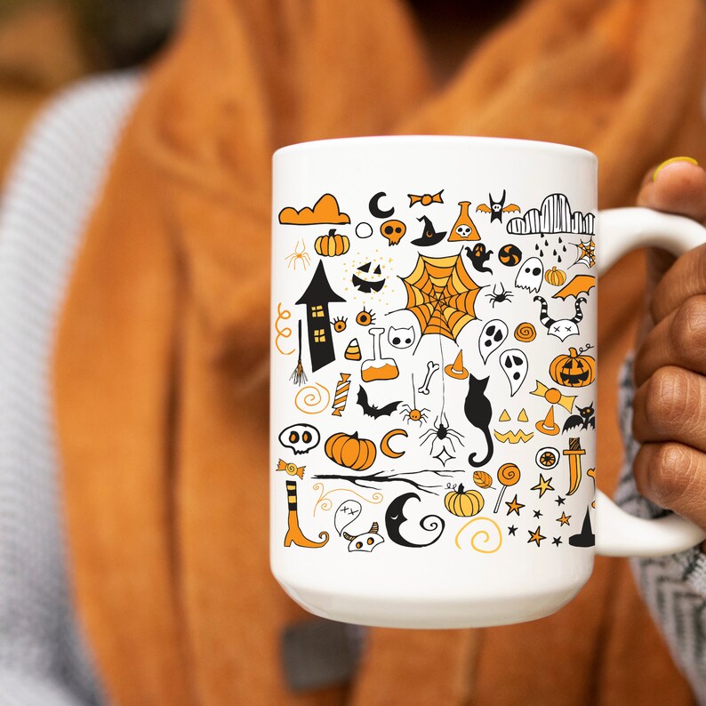 May include: White ceramic mug with a black and orange Halloween-themed design. The mug is covered in various Halloween icons, including ghosts, pumpkins, bats, spiders, and candy corn.