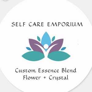 May include: A white circle with the text "SELF CARE EMPORIUM" at the top. A purple and teal lotus flower with a blue figure in the center is below the text. The text "Custom Essence Blend Flower + Crystal" is at the bottom.