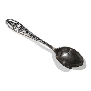 May include: Silver souvenir spoon with a design of a pine tree and the words "Green Mt State" and "Vermont" on the handle.