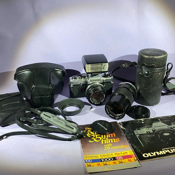 Vintage Olympus OM10 35mm SLR Film Camera + Olympus  50mm f/1.8 lens + Olympus 75-150mm f/4 lens + T20 Flash + cases Manual and hood