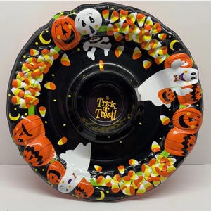May include: Black Halloween serving platter with a central dip bowl. The platter is decorated with orange pumpkins, white ghosts, candy corn, and a skeleton. The words "Trick or Treat!" are in the centre.
