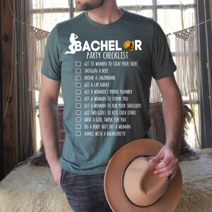 May include: A green t-shirt with a white graphic that says "Bachelor Party Checklist" and lists a humorous checklist of things to do at a bachelor party.