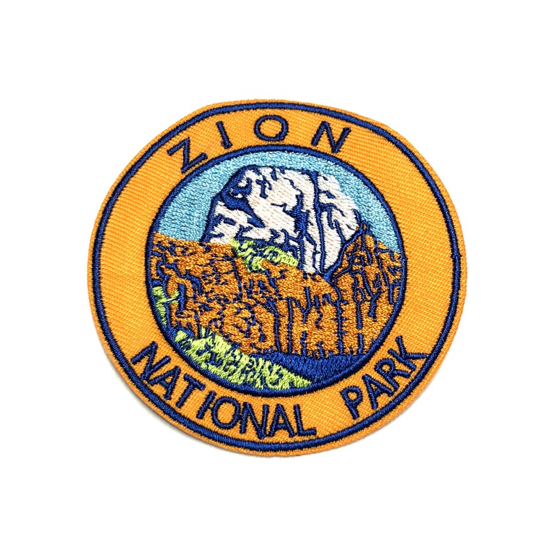 Zion National Park Souvenir Patch Utah, with Zion national Park wrote in the circle around the middle and in the middle a sewn image of a mountain and cliffs and a river