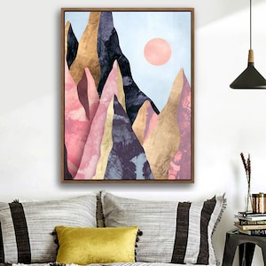May include: Abstract art print featuring a mountain range with pink, gold, and purple hues. The mountains are set against a light blue sky with a pink sun.