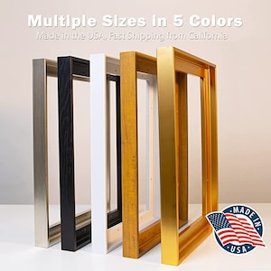 May include: Five picture frames in various colors: silver, black, white, wood grain, and gold. The frames are empty and stand upright. The text at the top says "Multiple Sizes in 5 Colors". A "Made in the USA" sticker is in the bottom right corner.